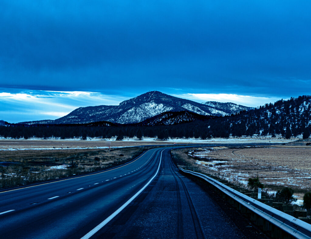 an empty road and a mountain