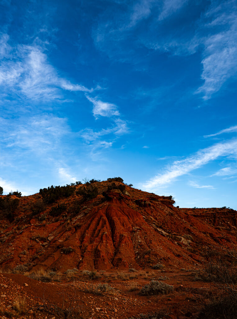 a red-clay hill in the desert